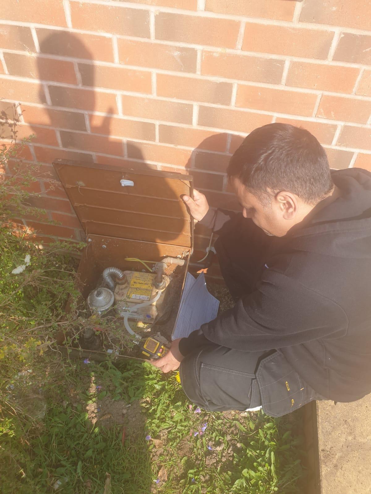 Outdoor gas meter safety inspection with testing equipment
