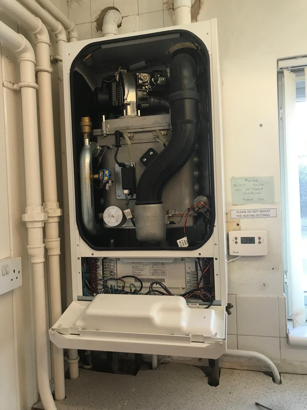 Boiler servicing with panel opened and manual checks