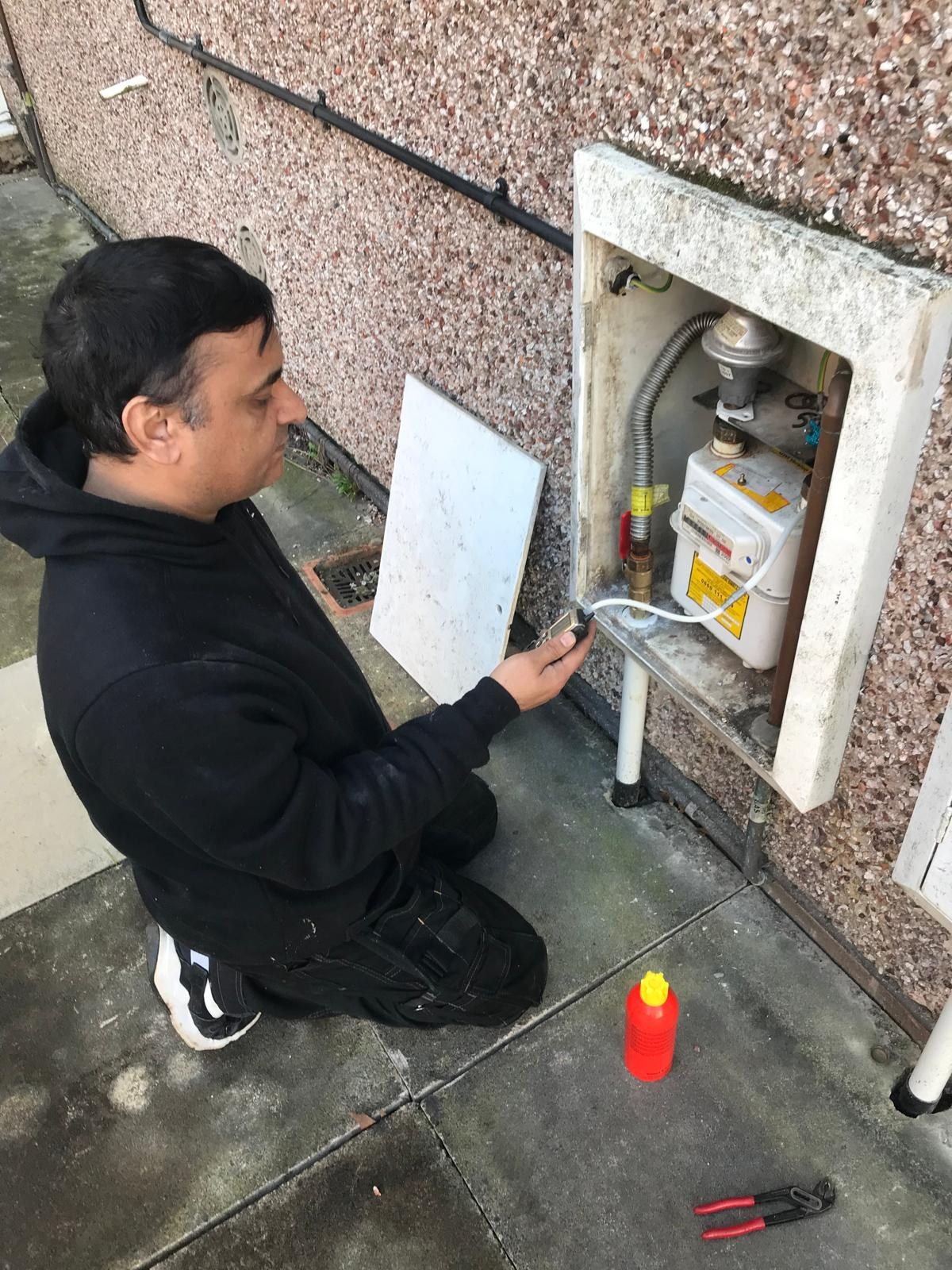 Engineer carrying out flue gas safety analysis on boiler
